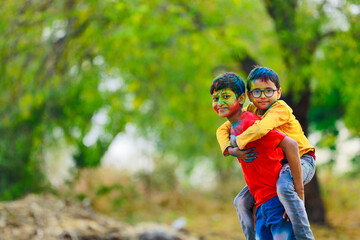 Cute indian little child playing holi. Holi is colors festival in india