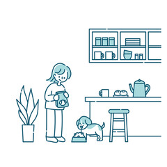 キッチンで犬にごはんをあげる女性