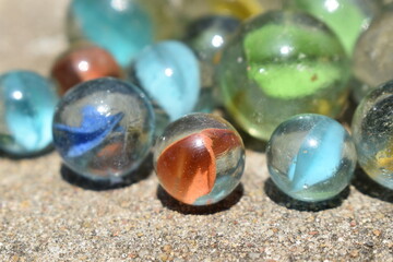 Colorful Playing Glass Balls. Glass blue ball. Abstract photo with Marble ball and reflection. Selective focus