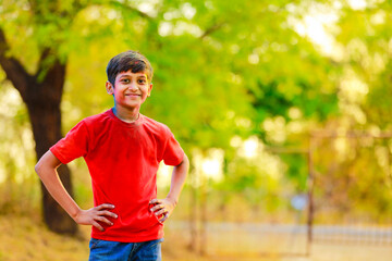 Fototapeta na wymiar Holi celebrations -Indian little boy playing Holi and showing face expression.