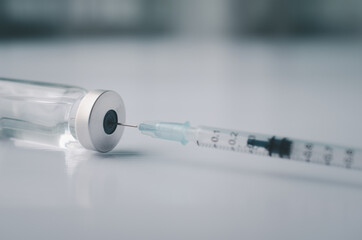 Syringe with liquid vaccines on table in laboratory,Concept covid-19 corona virus.