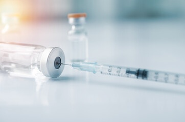 Syringe with liquid vaccines on table in laboratory,Concept covid-19 corona virus.