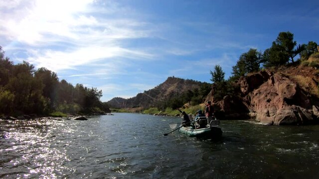 fly fishing on a scenic river along a rock cliff