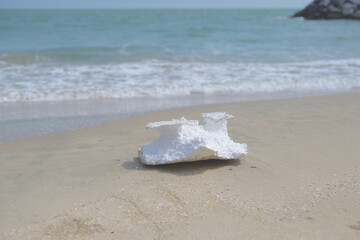 Styrofoam debris or garbage on the sand beach, marine debris pollution