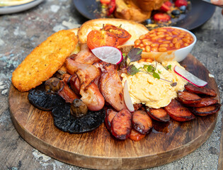 A big breakfast of eggs, baked beans, hash brown and chorizo