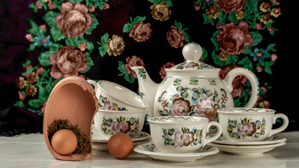 Passover still life with a tea set and Easter eggs.