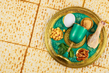 Fototapeta na wymiar Jewish matzah, kiddush and seder with egg, bone, herbs and walnuts. Passover concept.