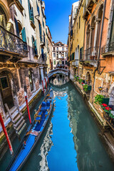 Fototapeta na wymiar Colorful Gondola Small Side Canal Bridge Venice Italy