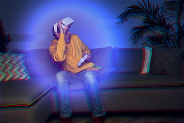 Fototapeta premium Man playing game at home using vr headset