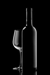 red wine bottle and wine glass isolated on black background