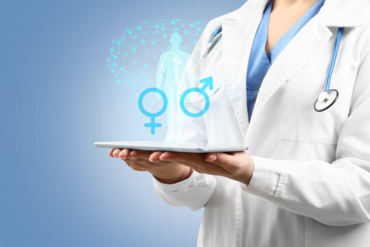 Female gynecologist with tablet computer on color background. Concept of sexual health