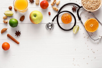 Naklejka na ściany i meble Healthy products, nuts and stethoscope on light background