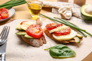 Board with fresh tasty bruschettas on color background