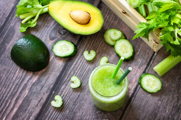 Vegan diet and nutrition, healthy detox, vegetarian concepts drinks. Green smoothie celery, avocado, cucumber and spinach on a rustic table. Top view flat lay.