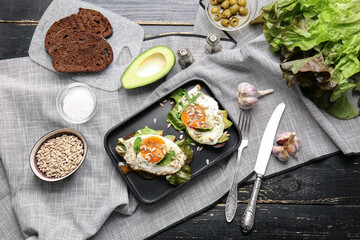 Tray with fresh tasty bruschettas on dark wooden background