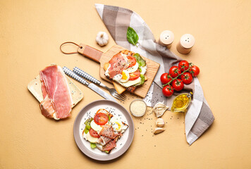 Plate and board with fresh tasty bruschettas on color background