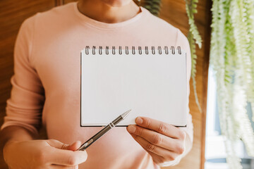 Man holding a notebook with blank background