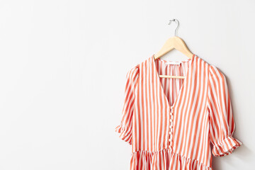 Hanger with blouse on white background