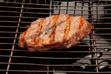Salmon steaks cooking on barbecue grill for summer outdoor party