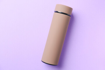 Modern thermos on color background
