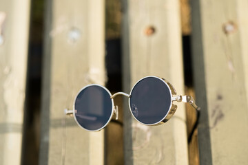 Steampunk sunglasses model with black lenses shoot outside in a summer day closeup. Selective Focus. High quality photo