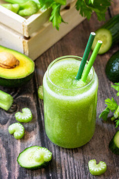 Vegan Diet And Nutrition, Healthy Detox, Vegetarian Concepts Drinks. Green Smoothie Celery, Avocado, Cucumber And Spinach On A Rustic Table.