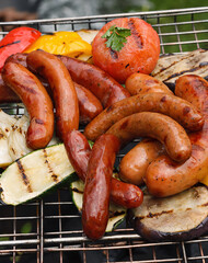 Sausages cooked on the grill with the grill