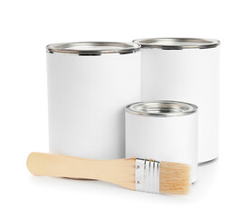 Cans of paint and brush on white background