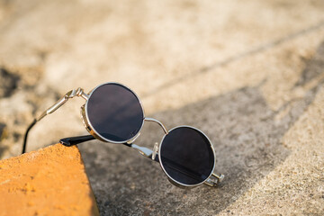 Fototapeta na wymiar Steampunk sunglasses model with black lenses shoot outside in a summer day closeup. Selective Focus. High quality photo