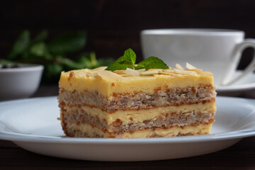 Banana sponge cake with nuts and mint. Delicious sweet dessert for tea, Dark wooden background.