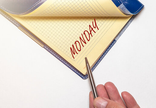 Word monday written in notebok, opened by hand