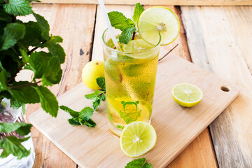 herbal healthy drinks cold lemon juice for health care with peppermint leaf and lemon slice on background wooden