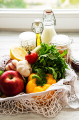 Zero waste concept. Eco bag with fruits and vegetables, glass jars with beans,  pasta. Eco-friendly shopping and cooking concept, flat lay.