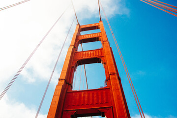 Close up of single tower of Golden Gate Bridge in white clouds San Francisco, USA, bottom view