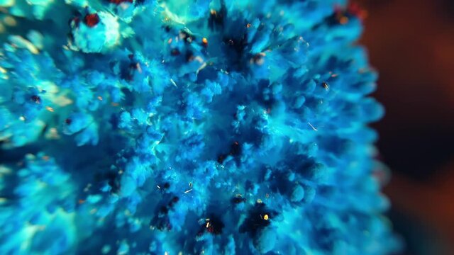 Macro of rotating pile of blue salt crystals. Abstract background of the movement of shining blue crystal particles