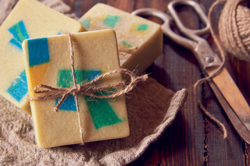 A fragrant organic handmade soap with a geometric pattern and packaging items.