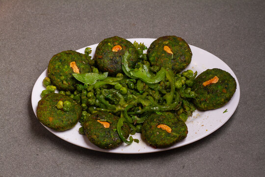 Hara bhara kabab or kebab is an Indian vegetarian snack recipe that is served with green mint cutney on a moody background. selective focus