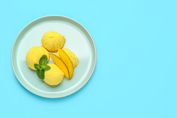 Plate of tasty mango ice-cream on color background