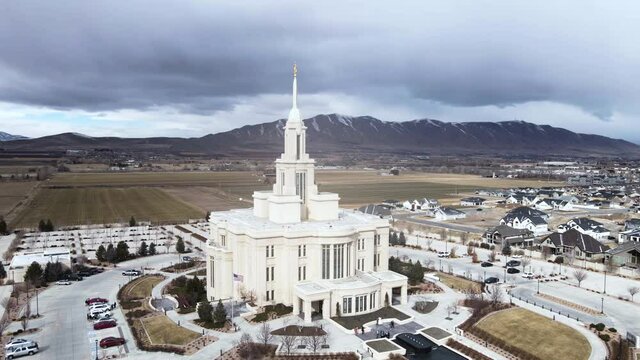Payson Utah LDS Mormon Temple on cloudy day. Aerial circling