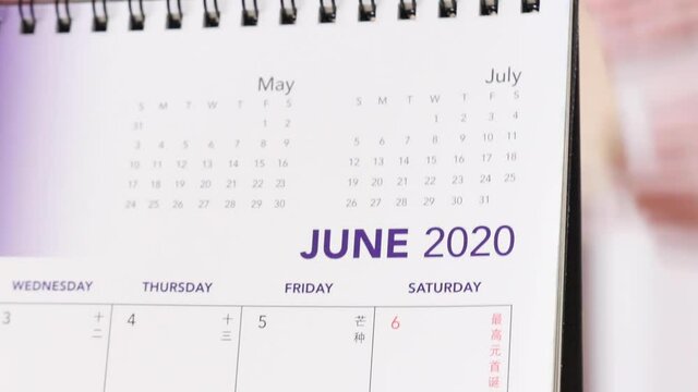 flipping calendar pages from may to june 2020 - close up 