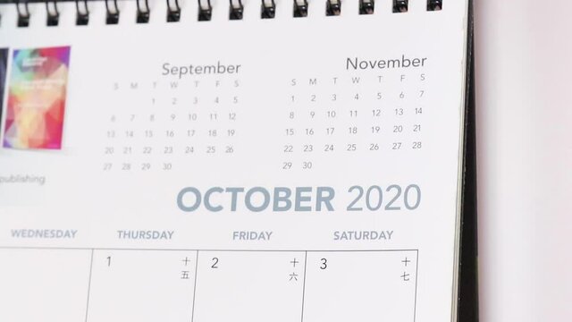 flipping calendar pages from september to october 2020 - close up 