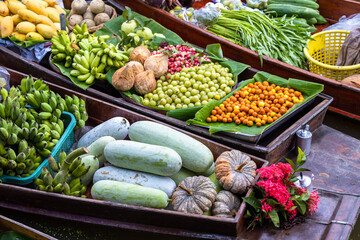 Aerial view famous floating market in Thailand, Damnoen Saduak floating market, Farmer go to sell organic products, fruits, vegetables and Thai cuisine, Tourists visiting by boat, Ratchaburi, Thailand