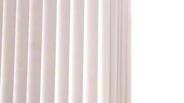 pulling vertical blinds curtain back revealing bright sunlight - medium 