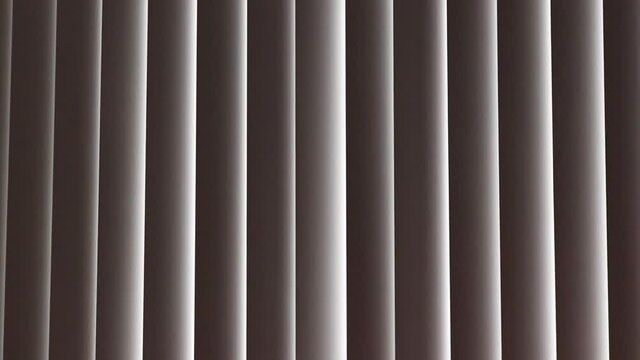 rustled vertical blinds curtain on window in office building - medium 