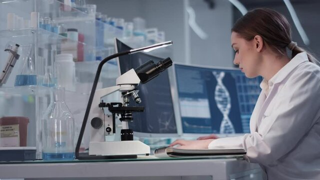 Female doctor working in laboratory. Studying human skeleton dna DNA samples