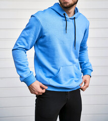 bearded guy wears blue hoodie. no logo color hoodie. clothing line mock up