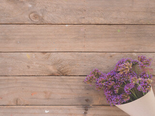 Purple verbena flower on the wooden table, top view