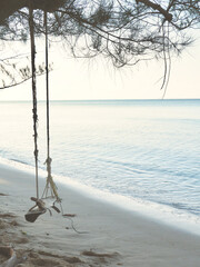Wooden swing on the beautiful sand beach