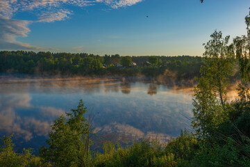 View of the adjacent village, located on the shore of Roshchinsky lake in the morning and sunrise....