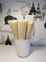 udon noodles in a white vase on the table.uncooked pasta